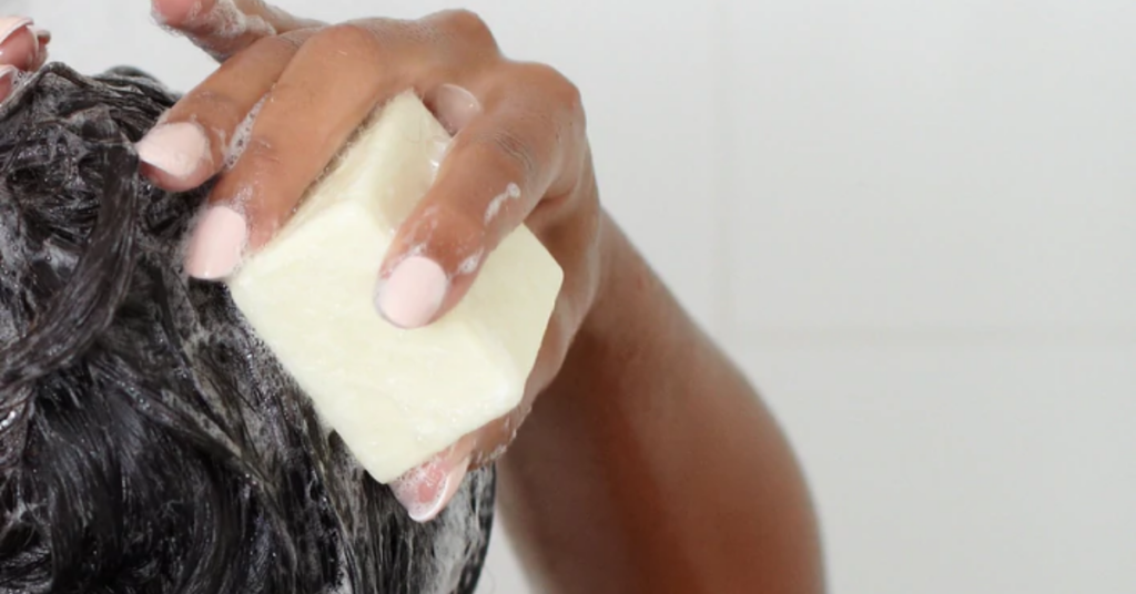 Person washing hair with an Ethique bar.