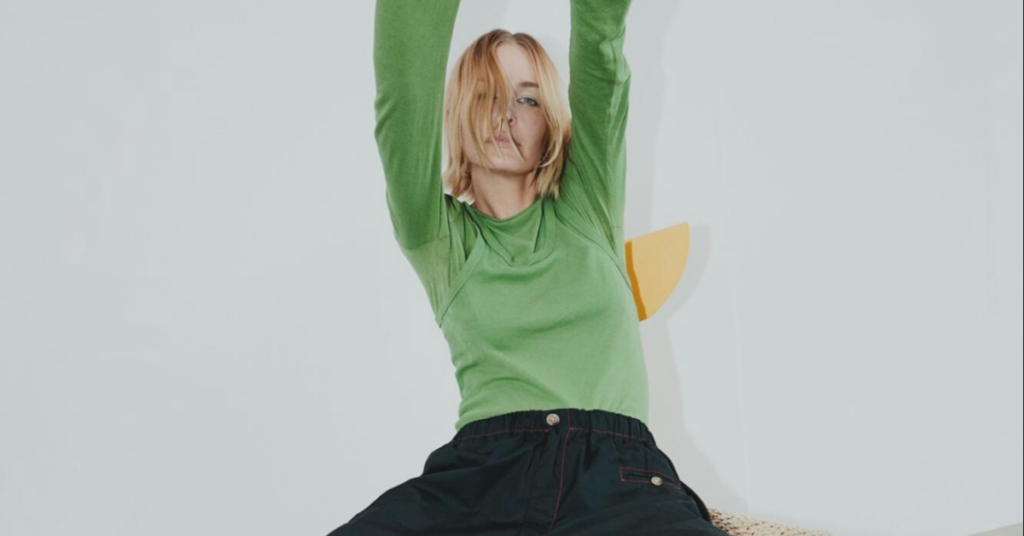 Woman wearing green long sleeve bassike top