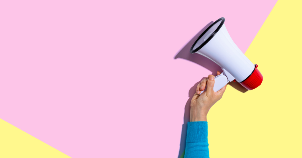 Someone holding a megaphone with pink and yellow background