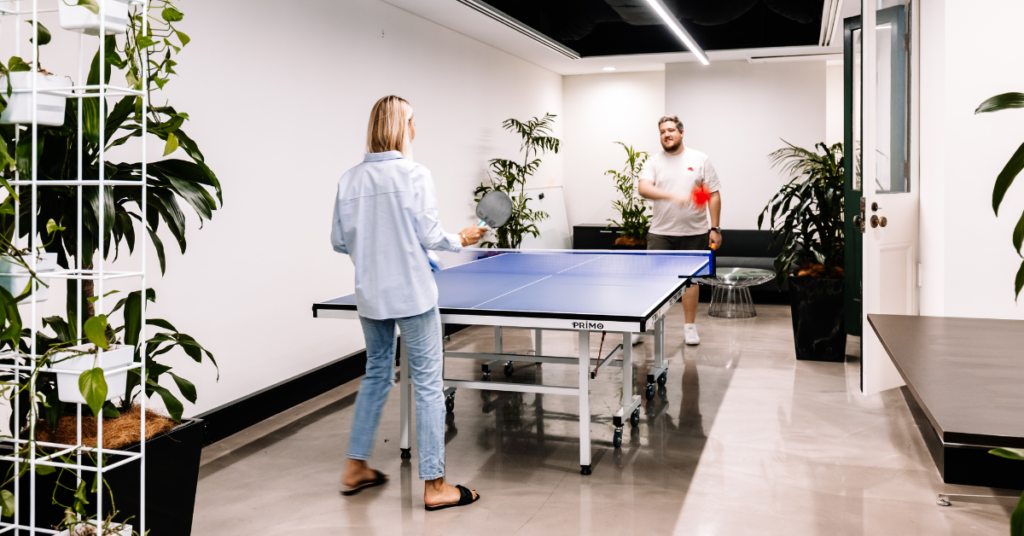 Two people playing table tennis