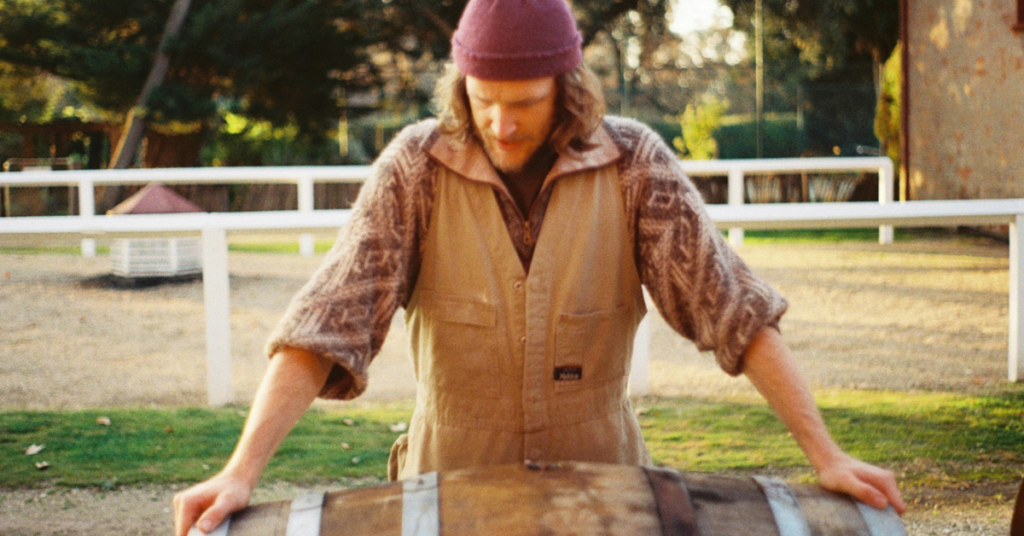 Person holding a wine barrell