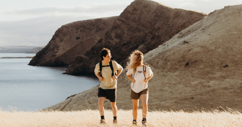 Two people hiking in the mountains with Zorali gear on.