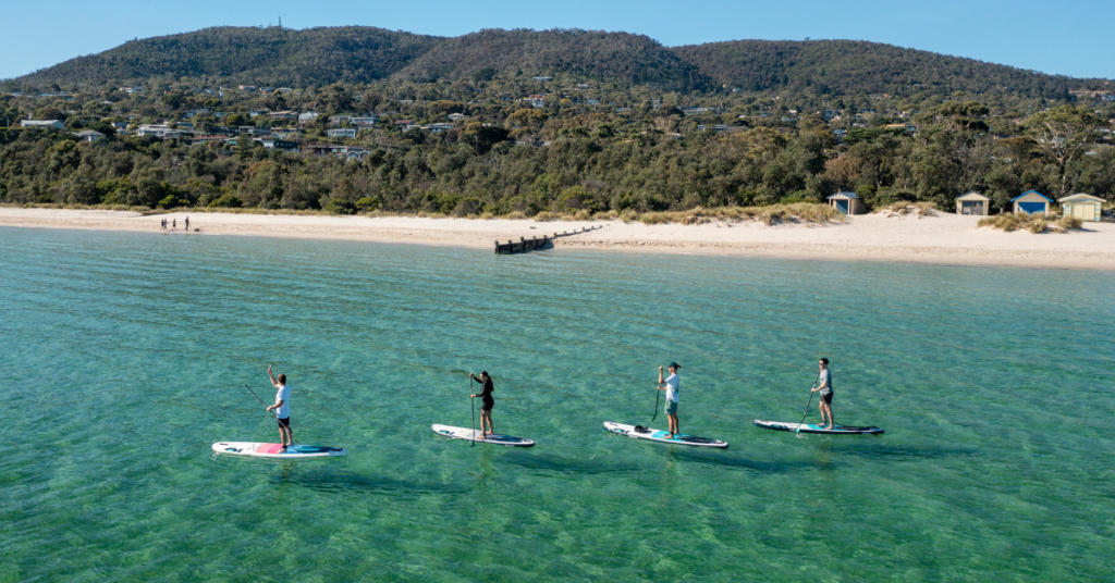 People stand up paddle (SUP) boarding