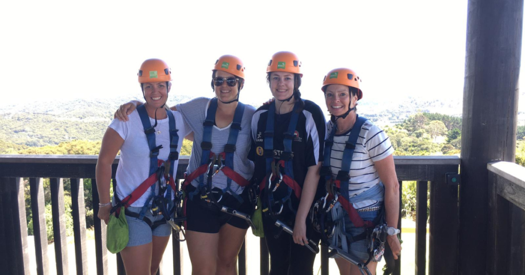 Four people zip lining 