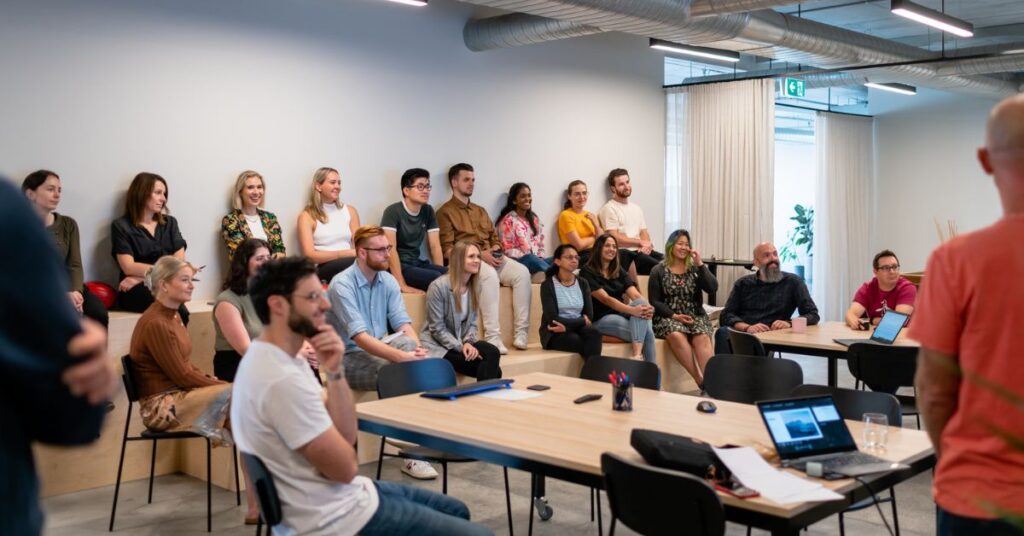 A group of 20 people watching a presentation
