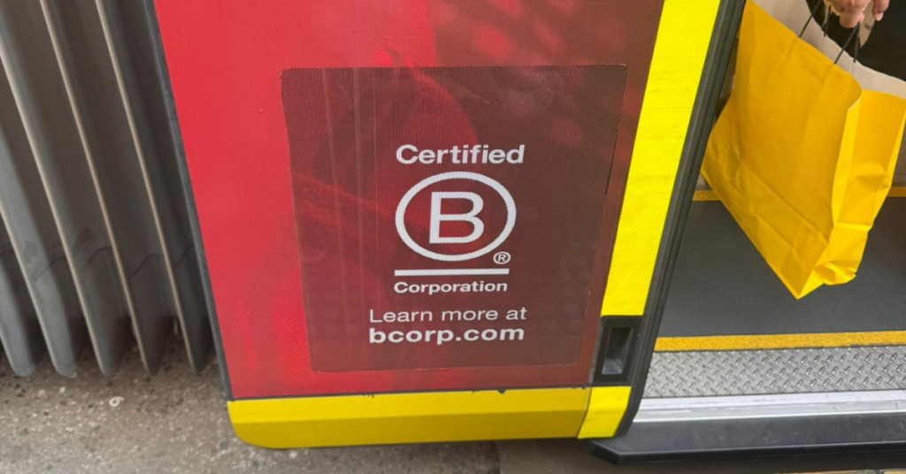 Certified B Corporation sign displayed on a tram door.