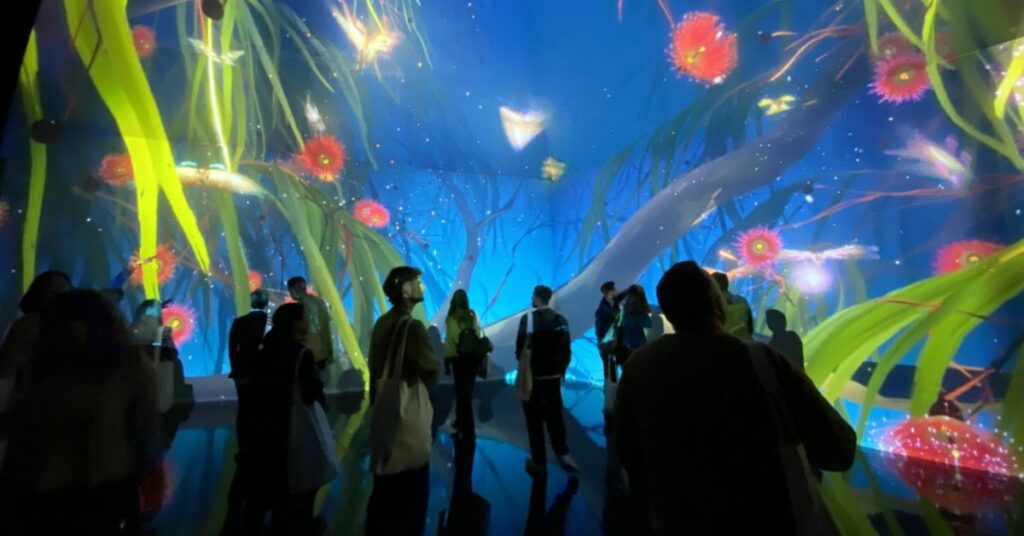 People looking at an art projection in a gallery