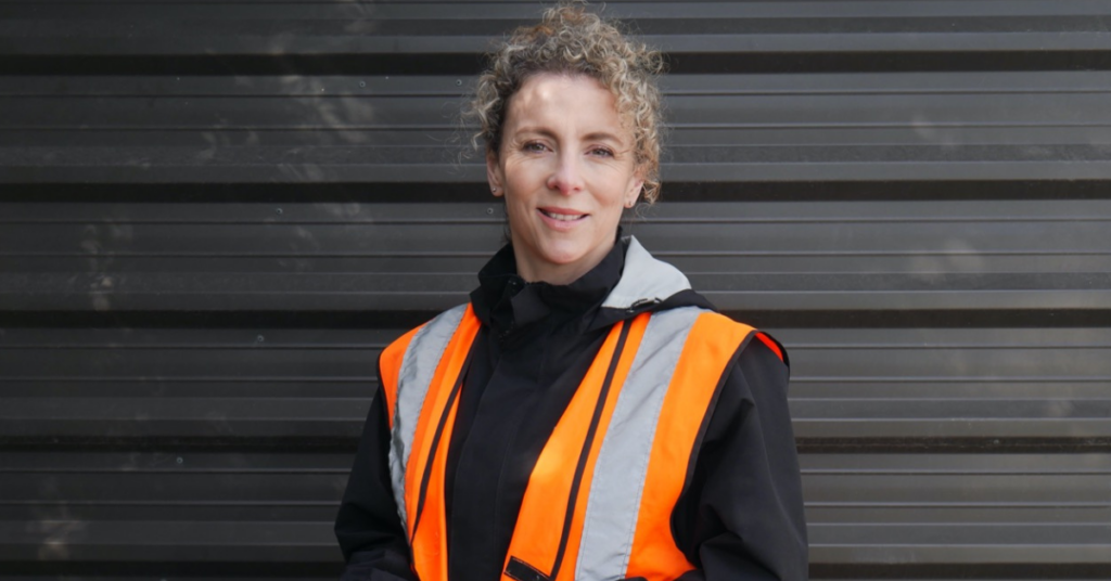 Person wearing high vis, smiling at camera