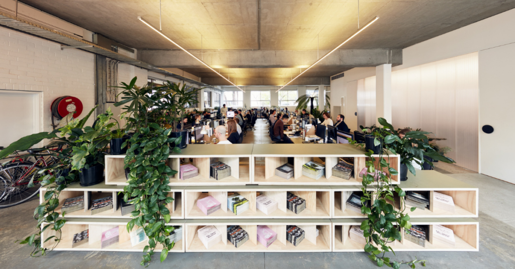 B Corp certified architecture and interior design studio Fieldwork workspace layout with books and plants.