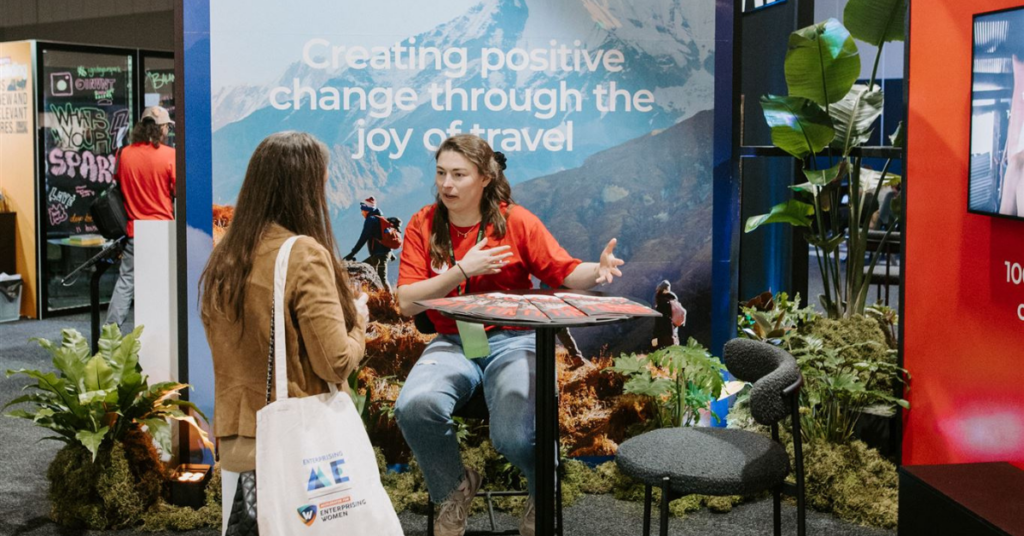 Intrepid travel team interacting with a customer at the B corp booth in SXSW Sydney