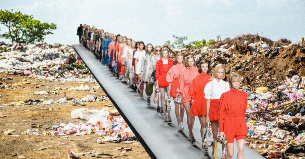 Fashion models on a runway next to a pile of textile waste. 