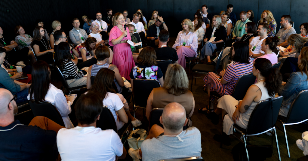 Angie, from B lab AANZ, speaking to a crowd of people siting in a circle