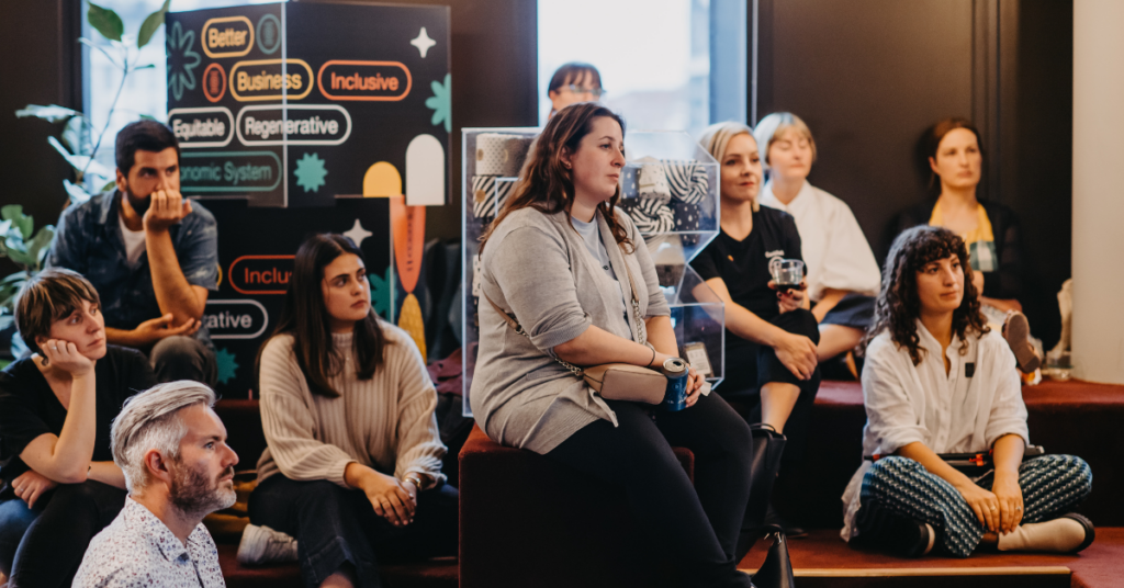 A group of people sitting and listening to a B Corp month event panellist