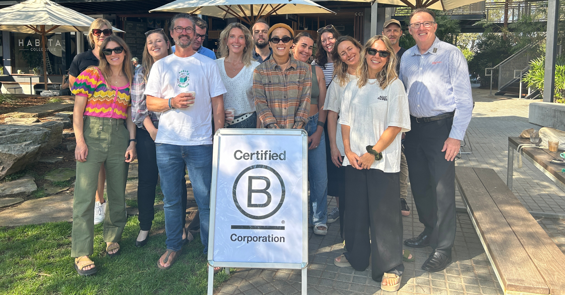 Summerland bank employees posing with a Certified B Corp signage