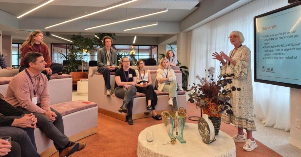 A woman giving a presentation in from of a group of people 