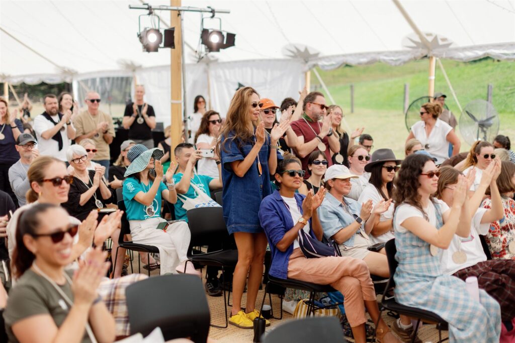 A picture of the audience clapping during a session at Assembly 2025.