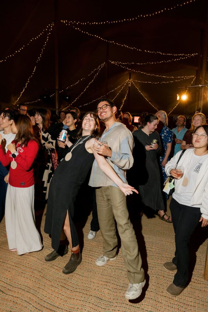 People in an audience enjoying a band and dancing