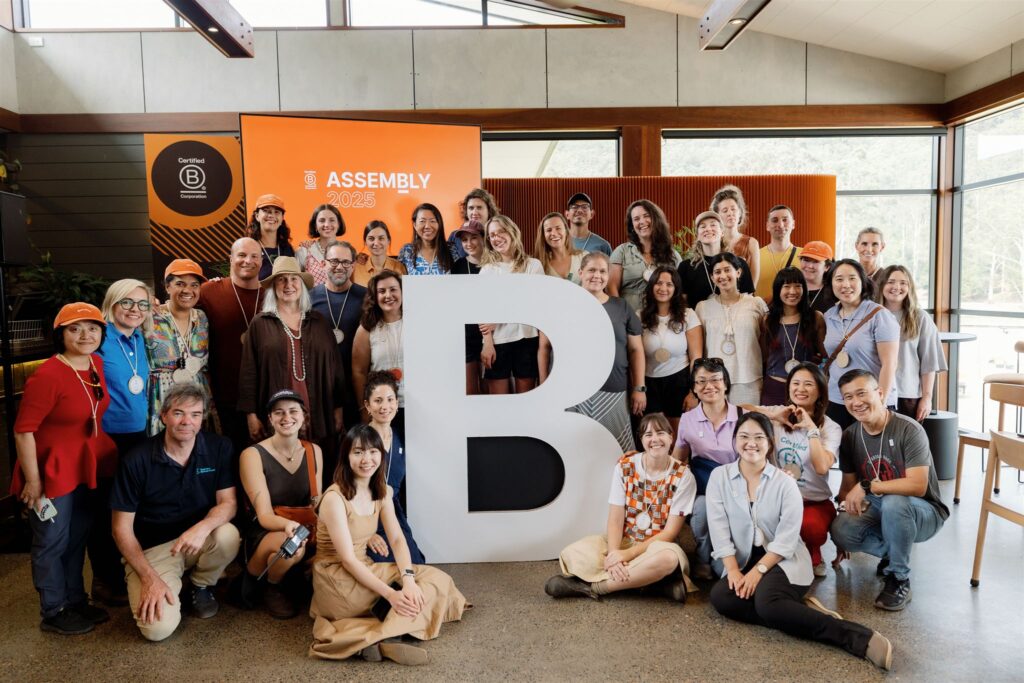 B Lab Australia, Aotearoa and global colleagues smiling around a large cut out 'B'