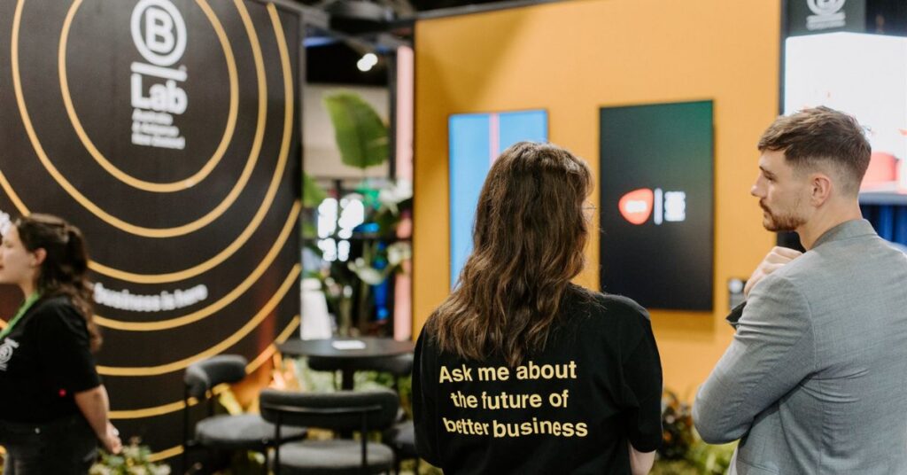 A women wearing a t shirt that says 'Ask me about the future of better business'