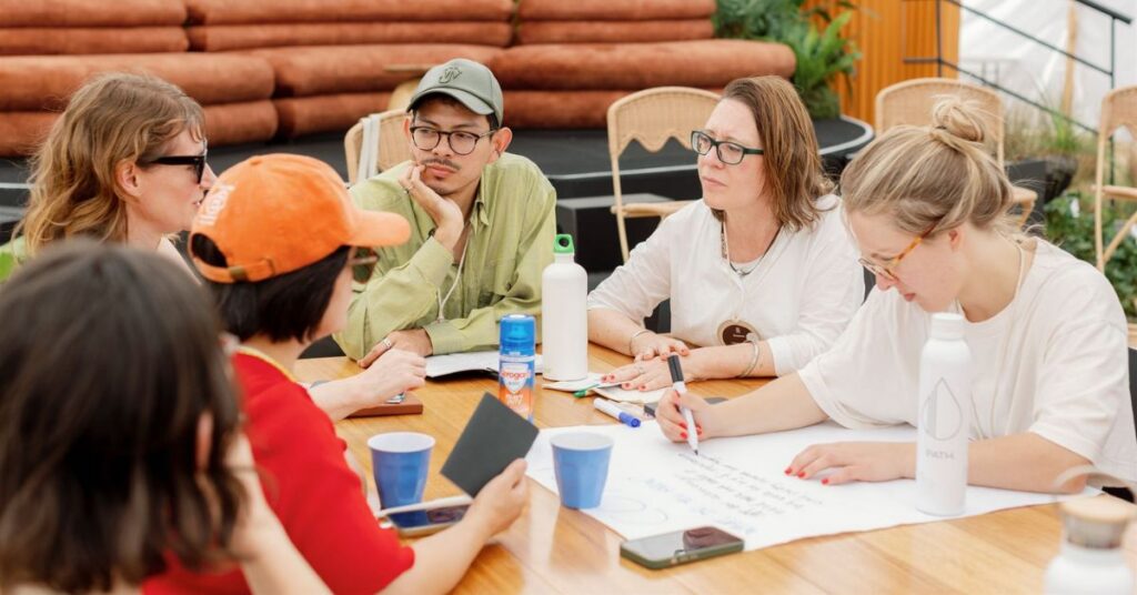 A group of people sat around a table at a standards workshop