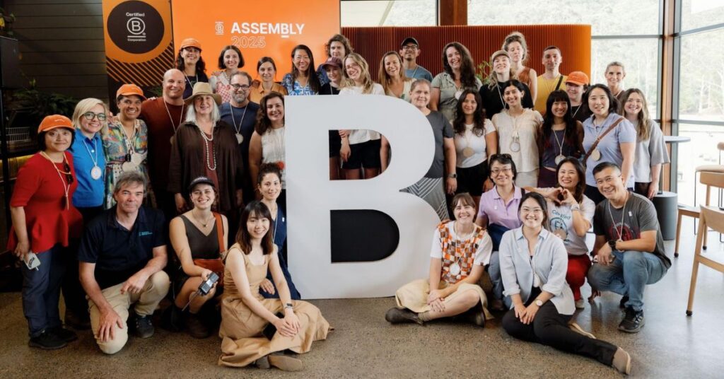 Group photo of B Lab AANZ Assembly 2025 attendees gathered around a large B Corp “B” sign.