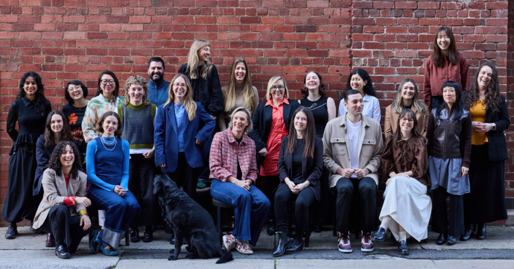 The B Lab AANZ team smiling in front of a brick background.