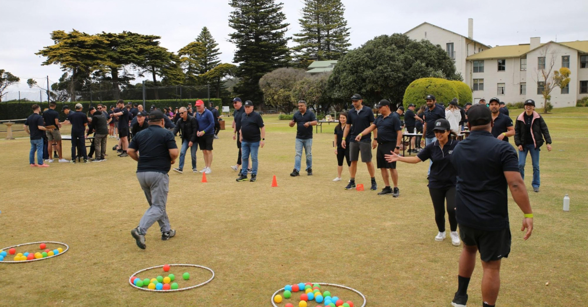 The DB Results team playing team games on some grass.