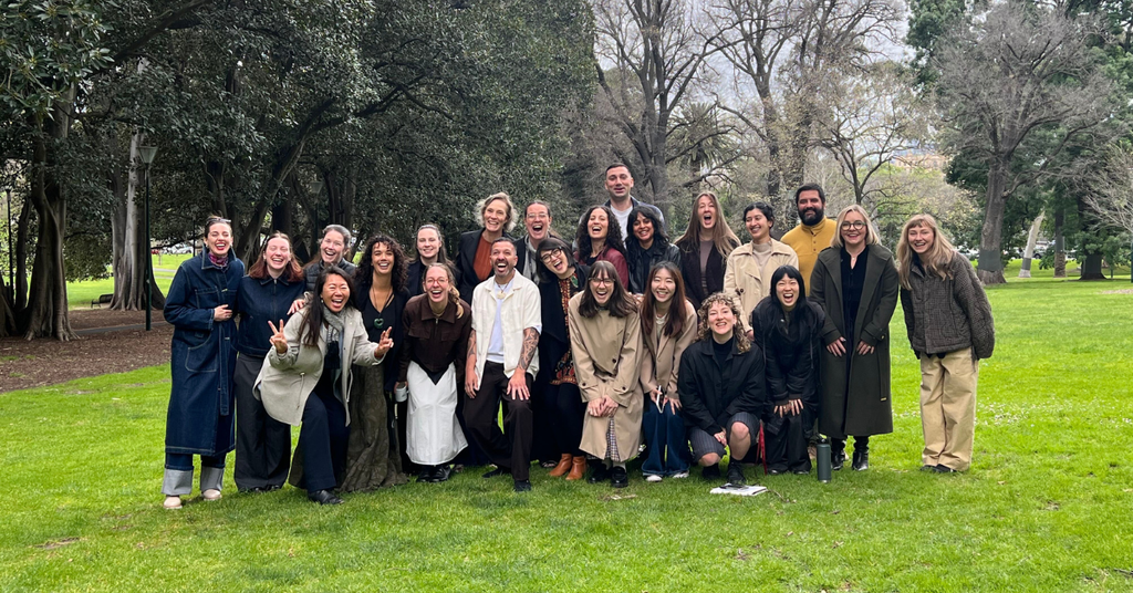The B Lab AANZ team stand in a park smiling with Jahmaine from AU Consulting.